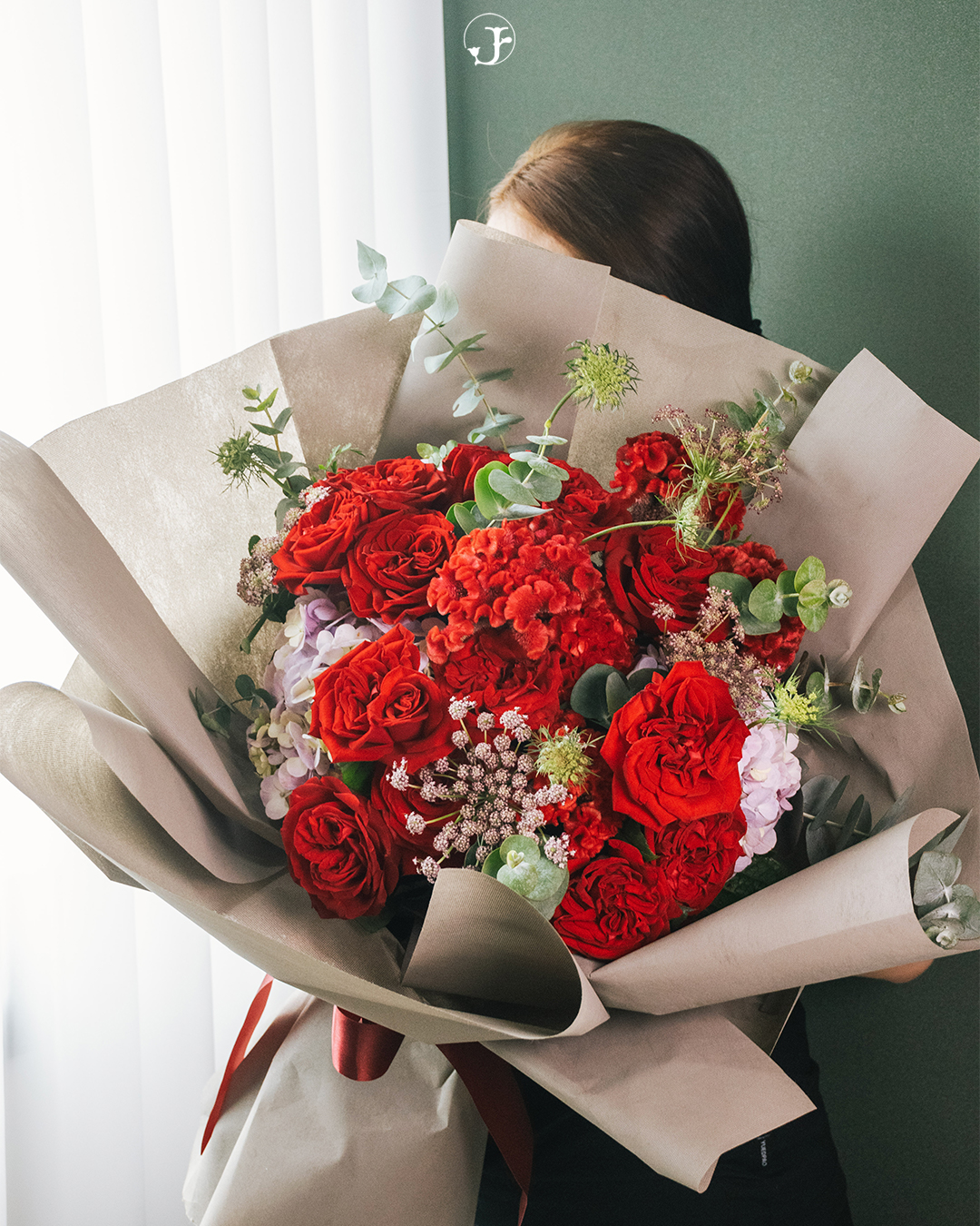 Large red bouquet held up